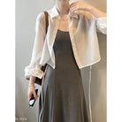 Dark sleeveless dress with sheer white shirt, styled with Comfy Sunrise Cardigan