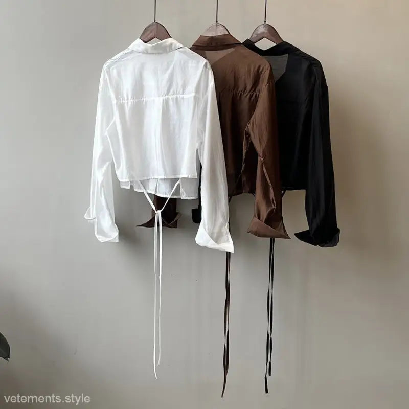 Three cropped button-up shirts in white, brown, and black for the Comfy Sunrise Cardigan