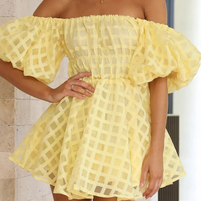 Yellow off-shoulder dress with a puffed sleeve design and lattice pattern fabric.