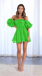 Bright green off-shoulder mini dress with puffy sleeves and a textured pattern.