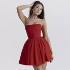 Strapless red cocktail dress with a fitted bodice and flared skirt.