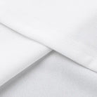 White fabric or textile material folded to show layers and texture.