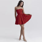 Red strapless cocktail dress with a flared skirt.