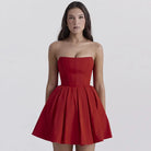 Strapless red cocktail dress with a fitted bodice and flared skirt.