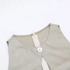 Beige sleeveless top with a button closure at the neckline.