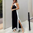 Long black and white halter-neck dress with a high side slit.