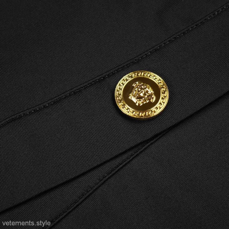 Gold Versace button detail on black fabric of Elegant Catwalk Cardigan Dress