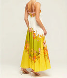 Floral maxi dress with a white bodice and yellow skirt featuring colorful flower prints.