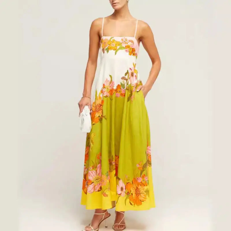 Floral print maxi dress with spaghetti straps and a white bodice transitioning to a lime green and yellow skirt.