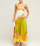 Floral maxi dress with spaghetti straps in white, lime green, and orange tones.