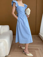 Light blue midi dress from the Elegant Flying Dress collection, featuring black ruffles