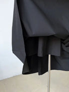 Black umbrella with a metal shaft partially visible.