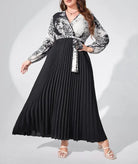 Long-sleeved maxi dress with a black pleated skirt and a white and black patterned top.