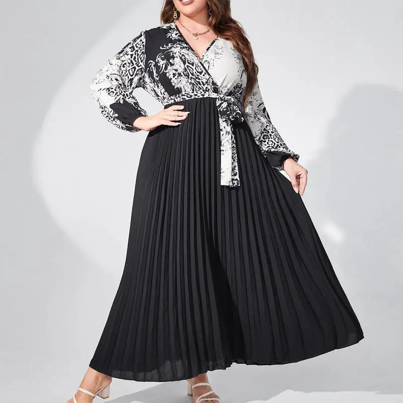 Long-sleeved maxi dress with a black and white patterned top and pleated black skirt.