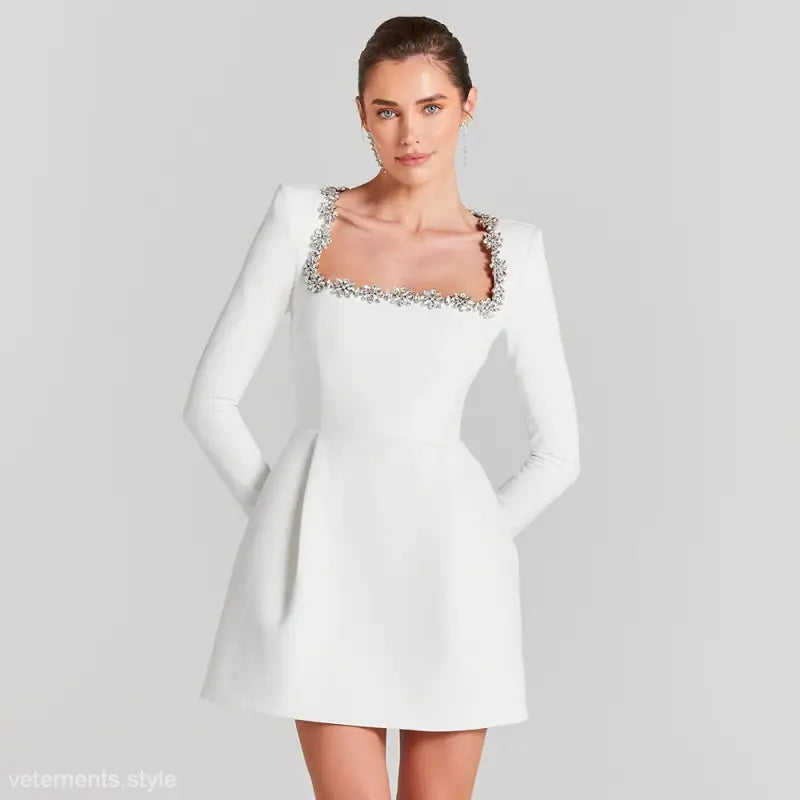 Elegant long sleeve stretch dress featuring a rhinestone square neckline and mini design