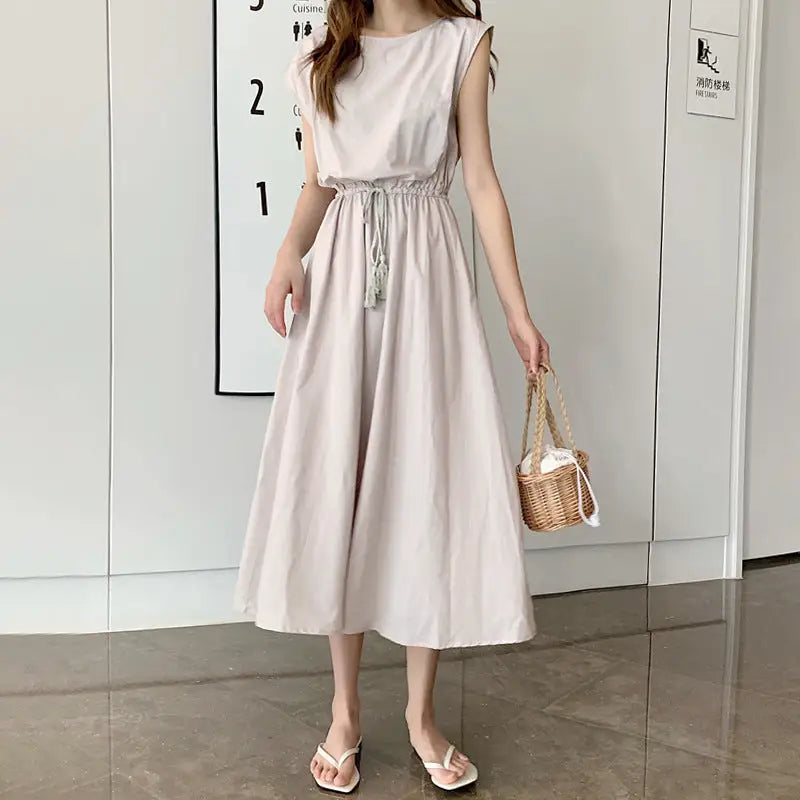 Sleeveless beige midi dress with a drawstring waist and flowy skirt.