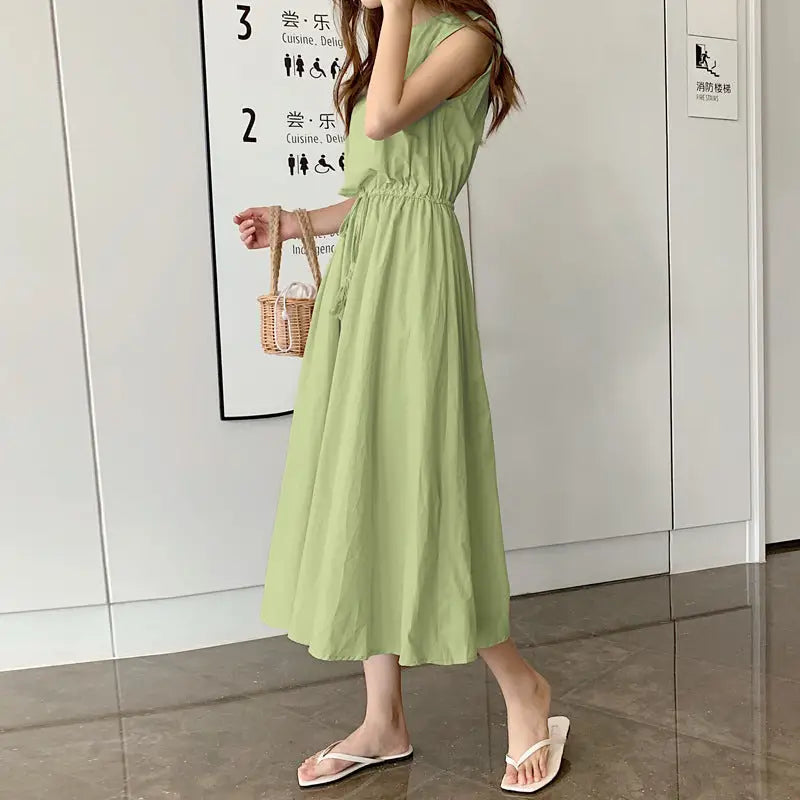 Light green sleeveless maxi dress with a cinched waist and flowing skirt.