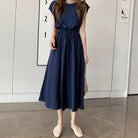 Navy blue midi dress with a cinched waist and cap sleeves.