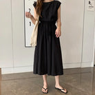 Black sleeveless maxi dress with a gathered waist and flowing skirt.