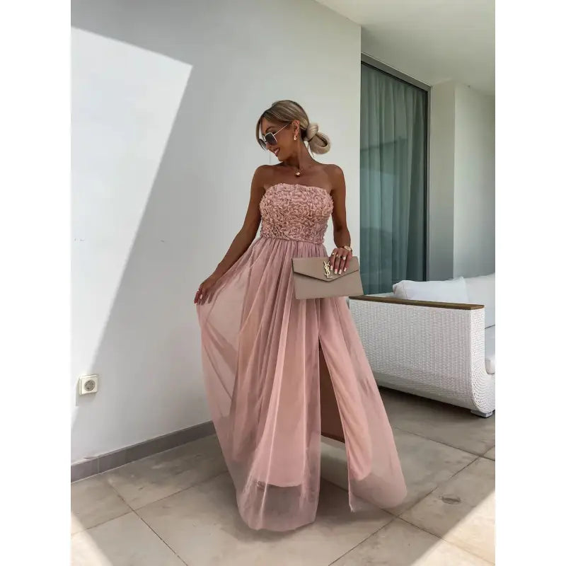 Elegant strapless pink gown with a flowing skirt and embellished bodice.