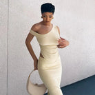 Elegant cream-colored bodycon dress with an asymmetrical neckline and cutout details.