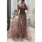 Floral one-shoulder evening gown with a thigh-high slit and sheer tulle overlay in pink and green hues.