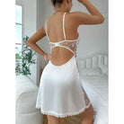 White lace-trimmed slip dress with an open back and floral embroidery details.