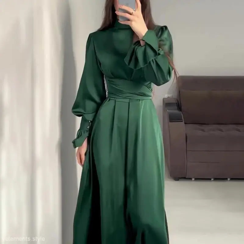 Elegant emerald green puff sleeve dress with cinched waist and high neckline