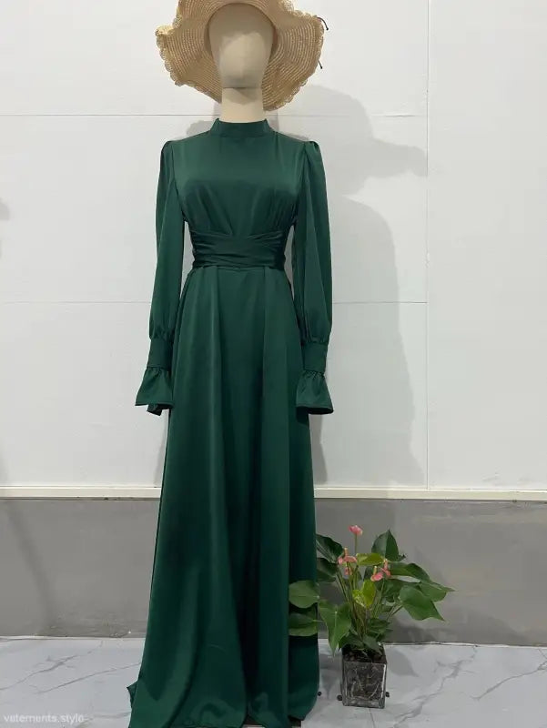 Elegant emerald green puff sleeve dress featuring a belted mock neck and flared skirt