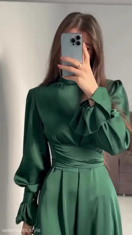 Elegant emerald green puff sleeve dress with long sleeves and fitted waist design