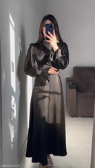 Elegant puff sleeve dress with billowy sleeves and cinched waist in a mirror selfie