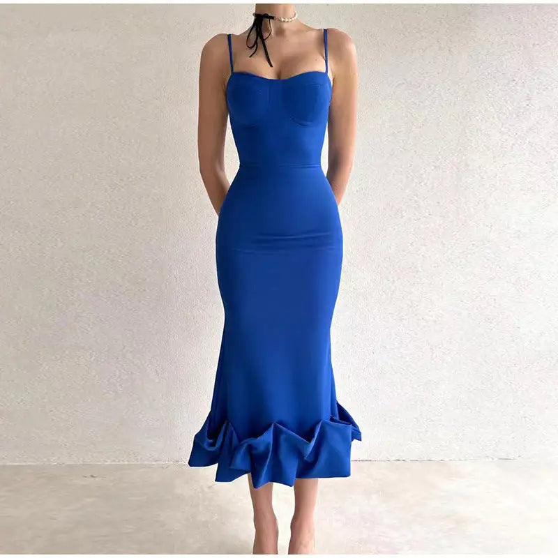 Vibrant blue form-fitting mermaid dress with spaghetti straps and a ruffled hem.