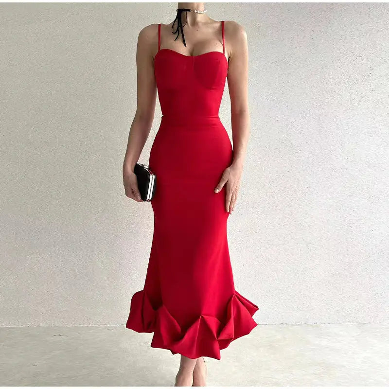 Vibrant red floor-length gown with spaghetti straps and a ruffled mermaid hem.