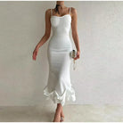 Elegant white bodycon dress with spaghetti straps and a ruffled hem.