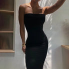 Sleek black bodycon dress with thin spaghetti straps.