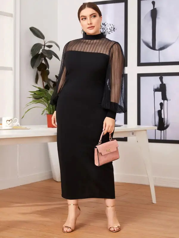 Elegant black midi dress with sheer sleeves and a high neckline.