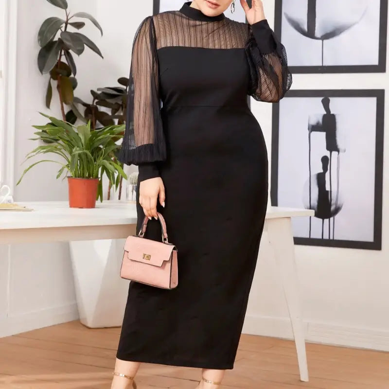 Elegant black bodycon dress with sheer long sleeves and a high neckline.