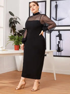 Elegant black dress with sheer long sleeves and a high neckline.