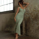 Mint green ruched mermaid-style dress with spaghetti straps and a sweetheart neckline.