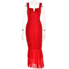 Red form-fitting mermaid-style dress with ruched bodice and sheer flared hem.