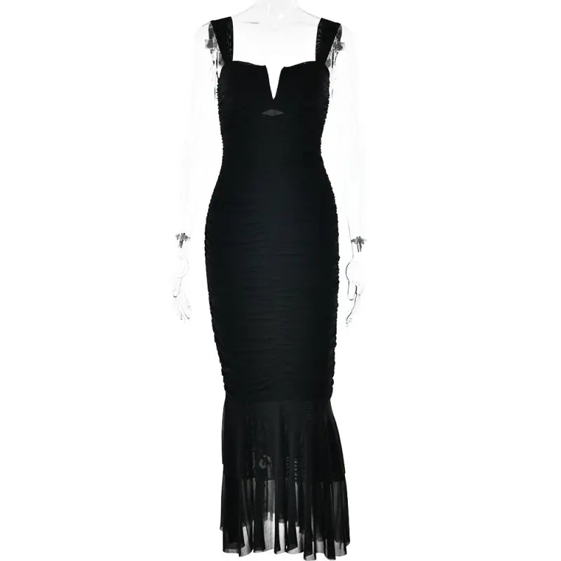 Black sleeveless mermaid-style evening gown with a plunging neckline and sheer hem.