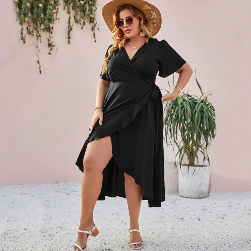 Black wrap dress with short sleeves and a high slit.