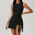 Sleeveless black mini dress with a side tie detail.