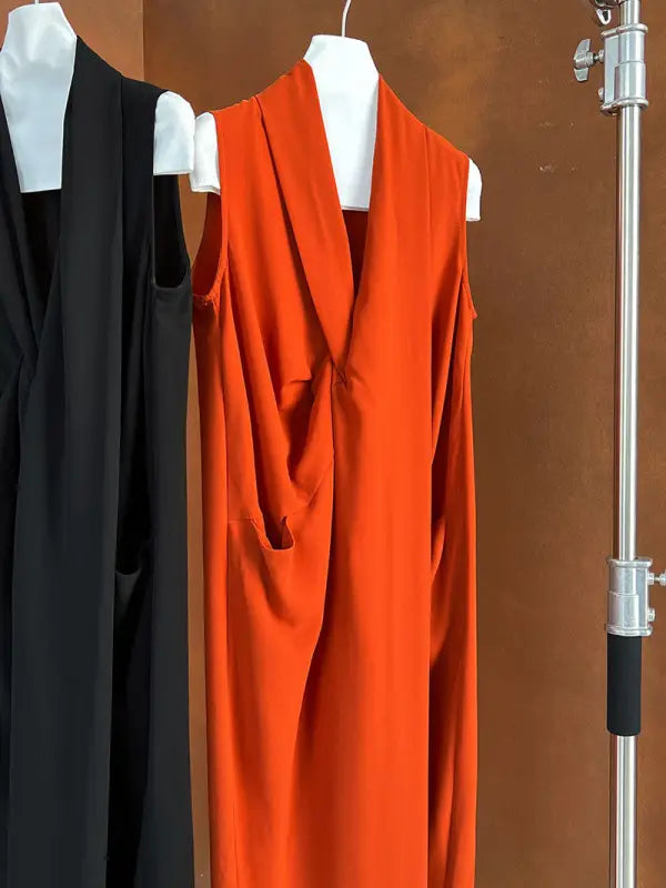 Bright orange sleeveless dress or long vest with a draped front.