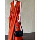 Sleeveless bright orange wrap dress with deep pockets.