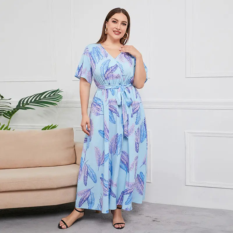 Blue and purple leaf-patterned maxi dress with short sleeves and a tie waist.