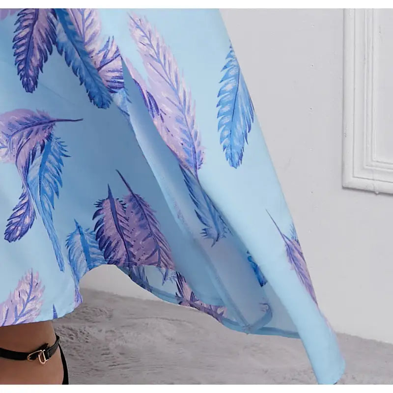 Flowing blue fabric with purple and pink feather patterns.