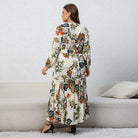 Long floral maxi dress with long sleeves and a ruffled hem.