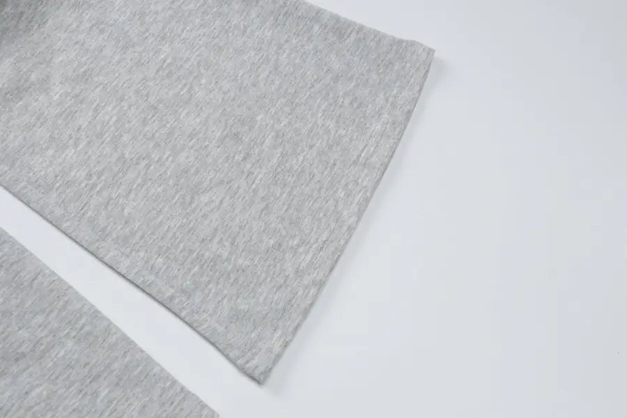 Gray textured sheet or fabric with a slightly mottled surface.