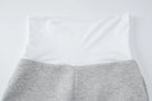 White pillow resting on gray fabric or bedding.